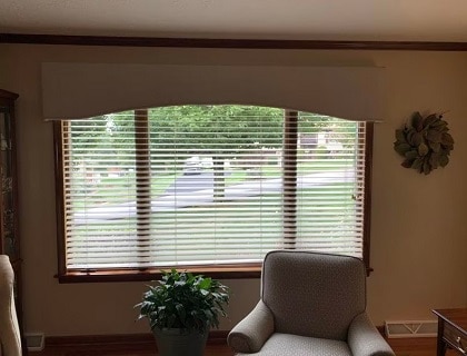 a large custom cornice board on top of a picturesque window in a living room