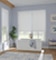 A minimal design purple bathroom with soaking tub in front of large window with white blackout cordless roller shades