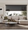 A modern living room with cream sectional in front of a large window with brown 10 percent energy saving solar screen shade