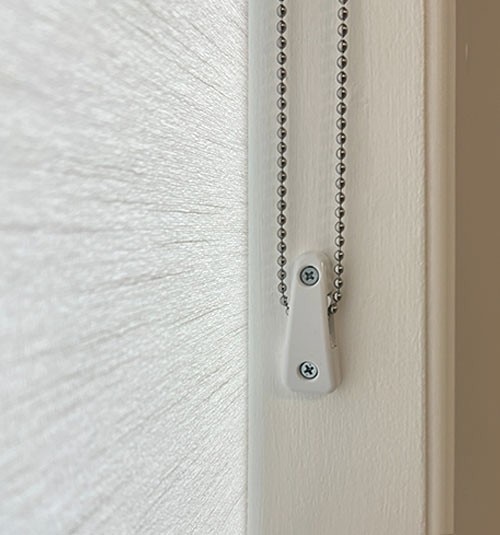 Close up of Cord Loop Tensioner. Tensioners must be wall mounted to operate shade