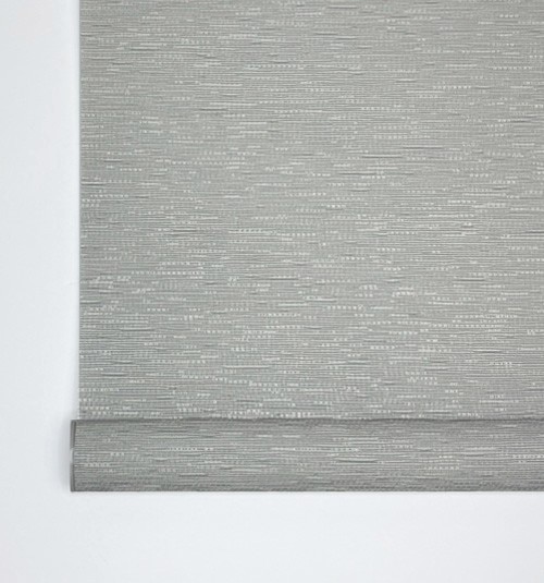 Close up of bottom fabric-wrapped rail. Front of bar is curved and comes wrapped with matching fabric. Back of bar is flat and shows color coordinated metal