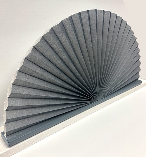 Stationary arches have one continuous bottom rail color coordinated to the selected fabric. The cell material slides on to a structural insert hidden in the rail. Remove rail end cap to slide out the frame to insert fabric.