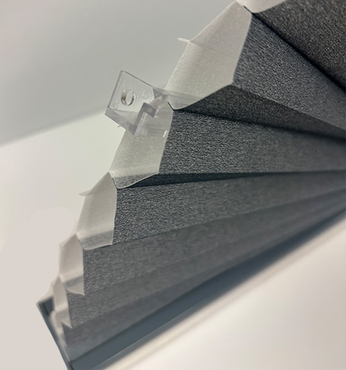 Clear fabric supports included to help maintain structure of arch. Top of the clear support clip should be screwed into wall and fabric can be gently pushed into the clip once installed.