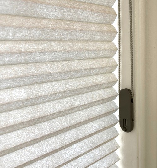 Cord Loop shades come with a tensioner that must be mounted to the frame or wall to operate properly. Tensioner color will be coordinated to the selected fabric.