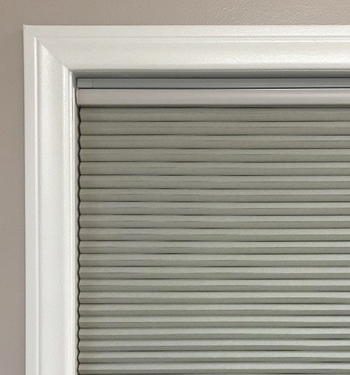 No-Drill headrail has a slim profile but will  still be visible at the top of the shade. Some light may seep through in the space between the shade and headrail.
