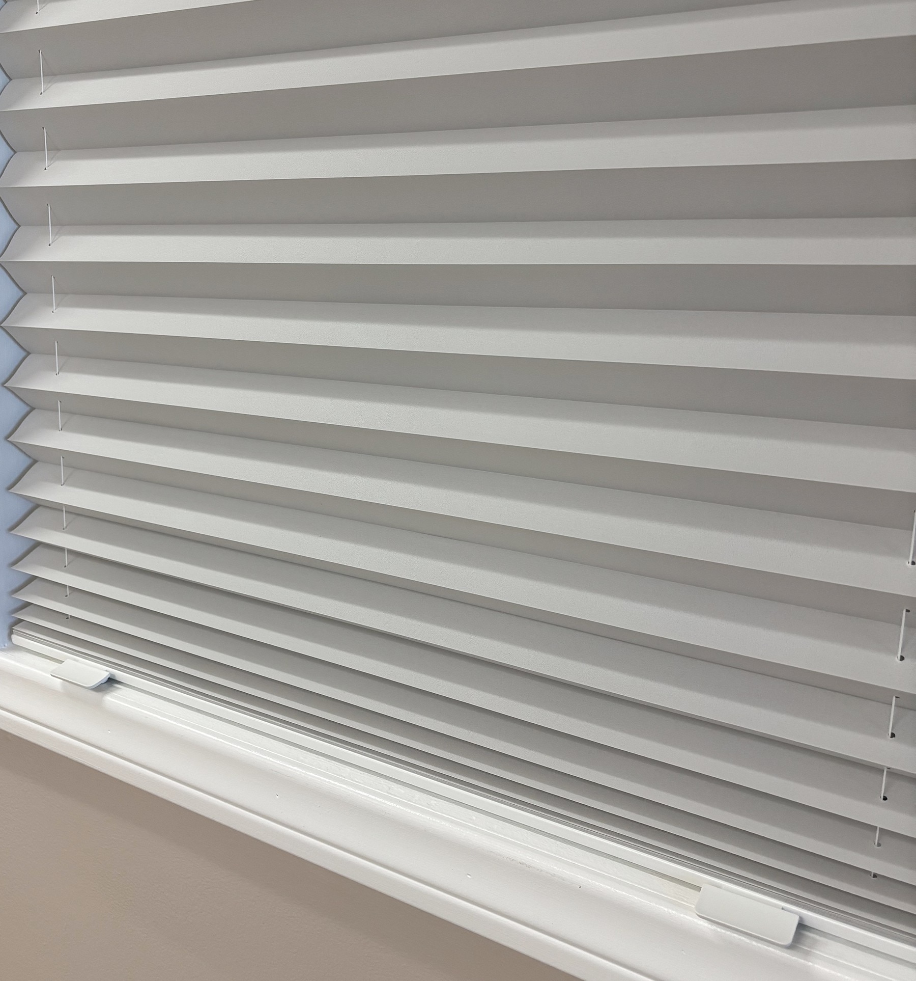 Cordless shades come with two color coordinated handles. Handles slide on to pre-installed notches.