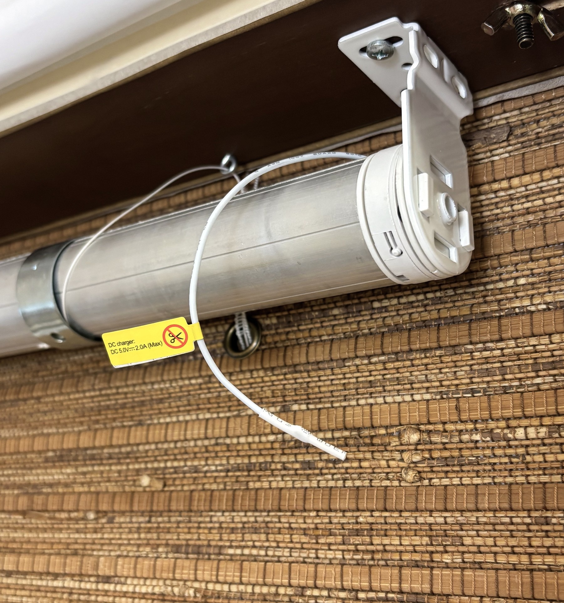 View of motorized tube under valance. Charging port and reset button can be found on the end of the tube. 