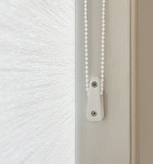 Close-up of Cord Loop Tensioner. Tensioners must be wall-mounted to properly operate shade.