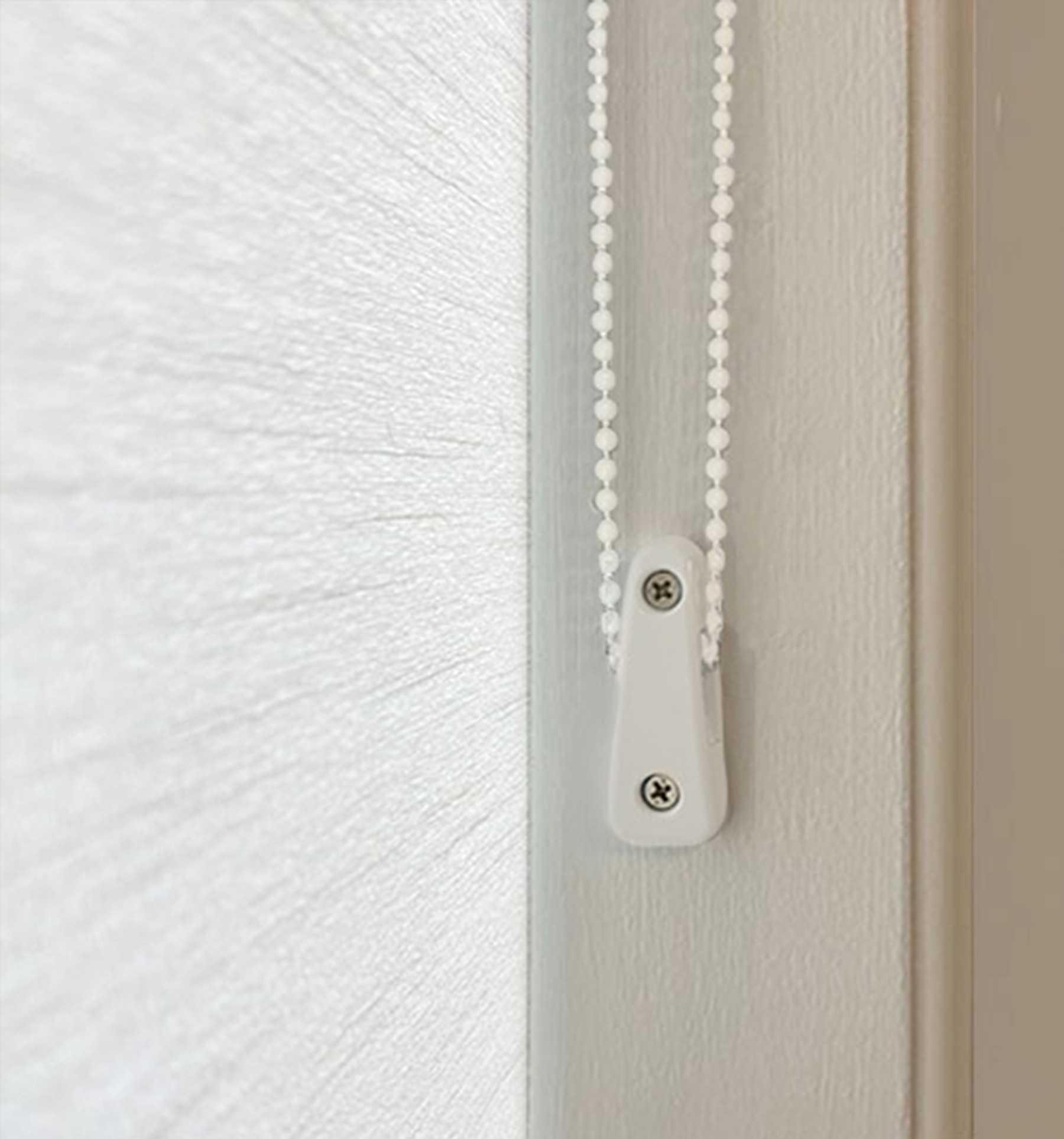 Close-up of Cord Loop Tensioner. Tensioners must be wall-mounted to properly operate shade.