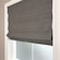 Blindsgalore Essential Roman Shade shown in flat fold with cordless lift. Shown in Newport Smoke.