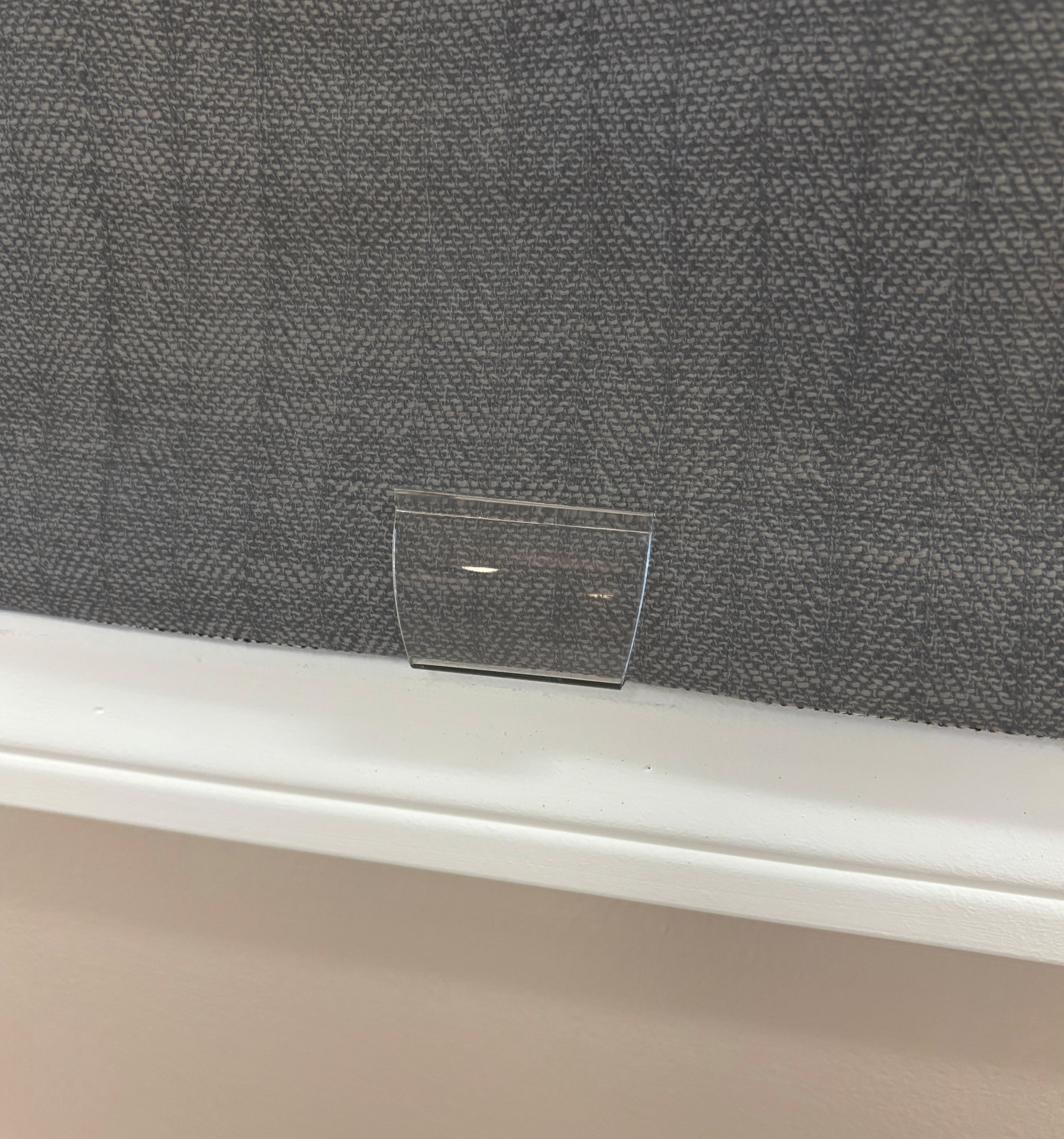 Clear handle is provided for cordless lift shades. Handle can be removed.