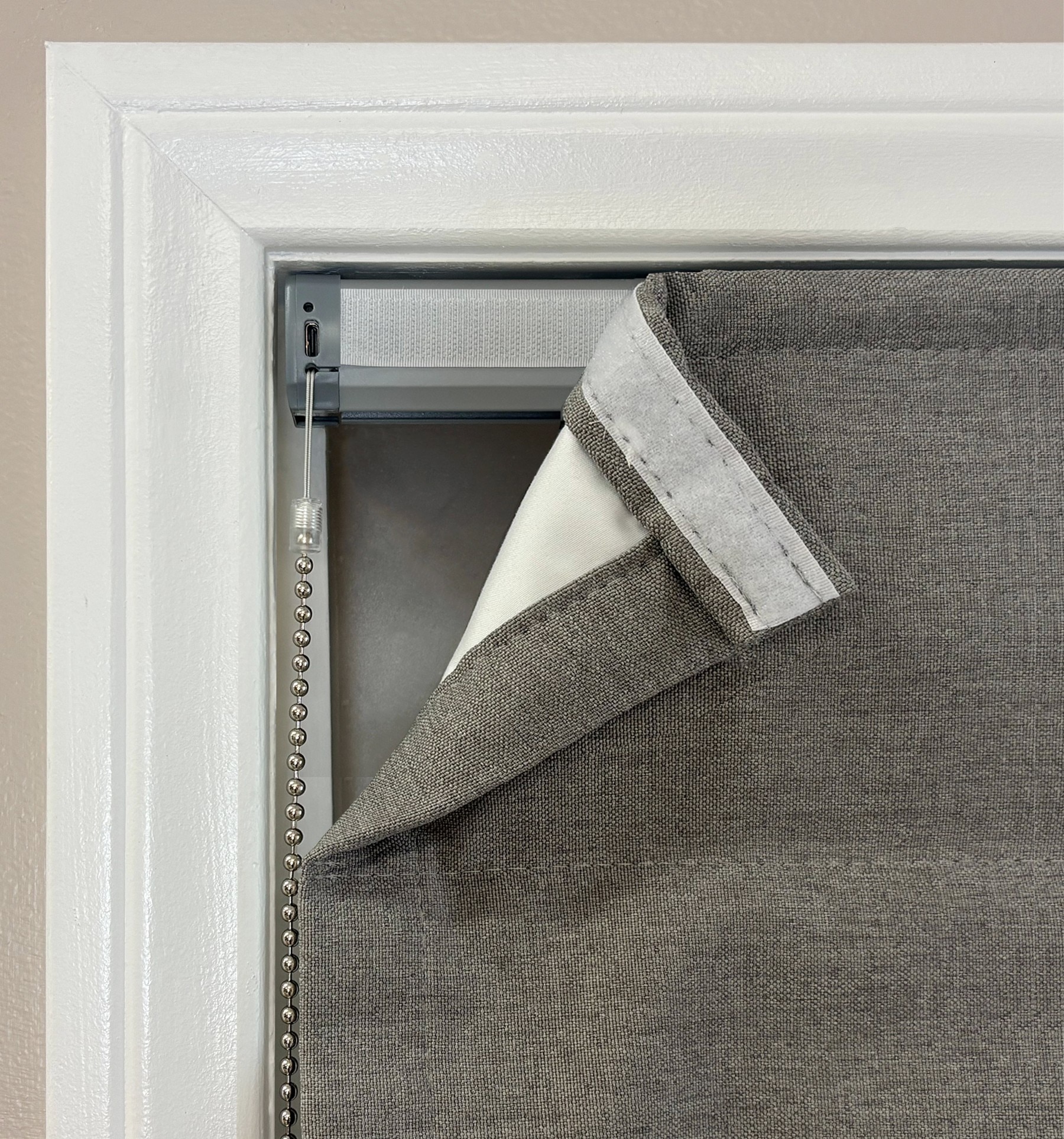 Motorized headrail can be recharged via USB-C port. Roman fabric will cover front of headrail for sleek look. 