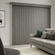 Blindsgalore Faux Wood Vertical Blinds shown in Woodgrain Lead
