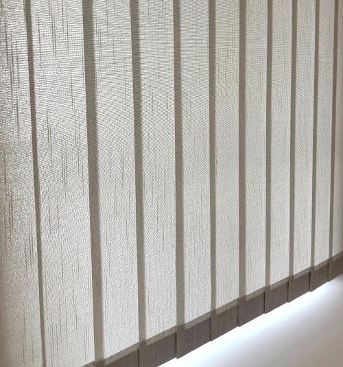 Close up of closed free hanging fabric vanes; shown in Flaxen Light Gray