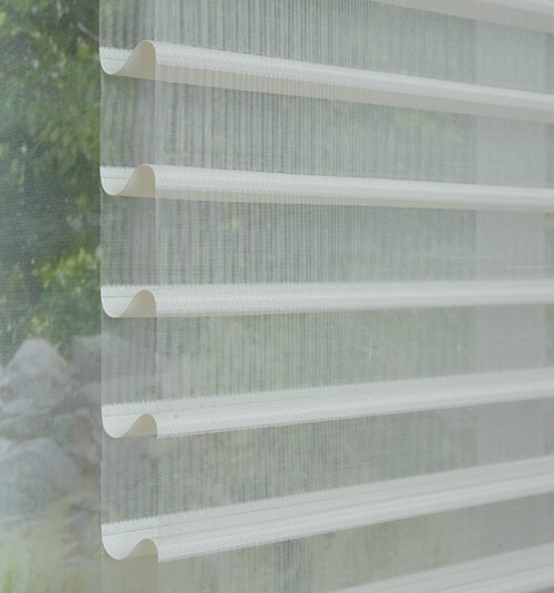 White sheer shades with open vanes