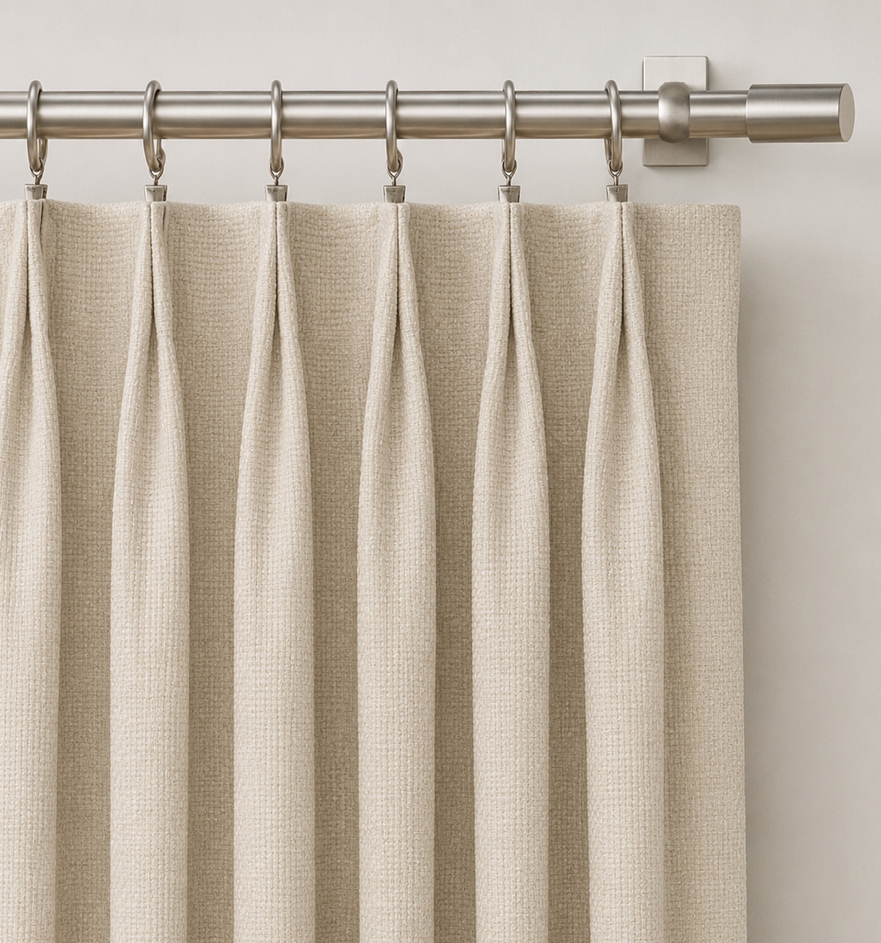 Crown Pleat features a classic two finger pleat tacked at the top for a sleek look.  Pleated draperies are attached to a rod using pre-pinned hooks and drapery rings. Drapery rings are not included.