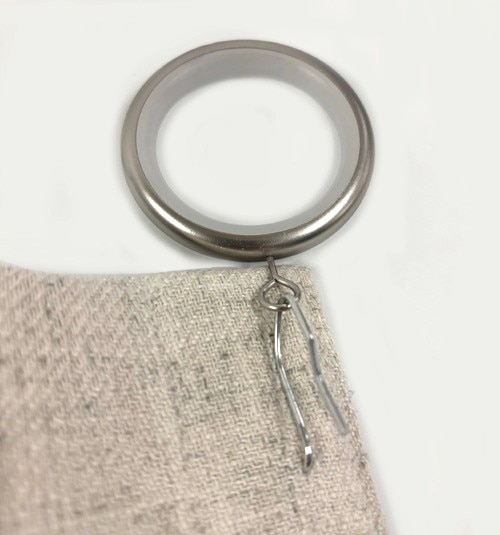 Close up of silver pinch pleat attachment ring on pin.